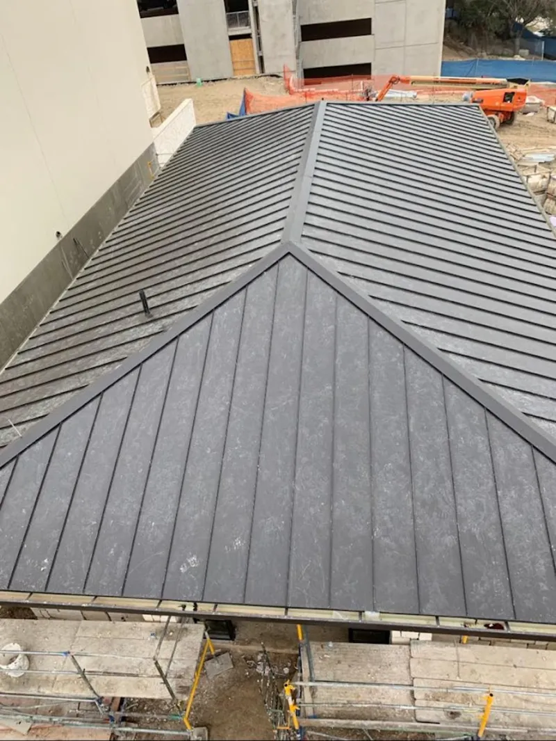 Commercial metal roof construction with crane equipment in Florida Ridge